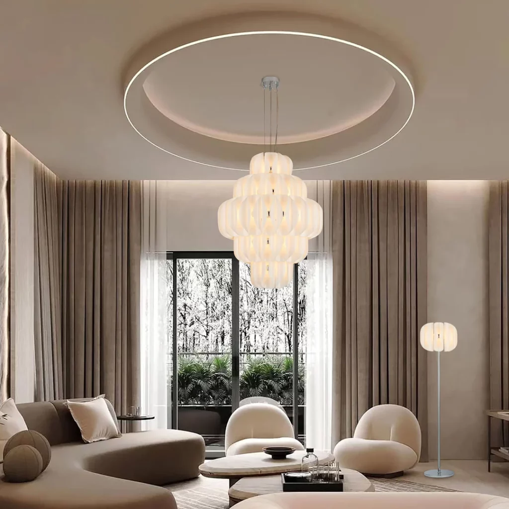 Interior lighting is one of the most important elements in high-end space design. It affects how a room looks, how people feel and how materials, colors and textures are perceived. A beautiful interior can lose its impact if the lighting is flat, cold or poorly positioned. On the other hand, well-planned lighting can make a space feel warmer, deeper, more luxurious and more comfortable. For hotels, villas, private residences, restaurants and refined commercial interiors, lighting should not be treated as a final decoration. It should be part of the design from the beginning. This is where bespoke interior lighting becomes valuable. At Gusure Lighting, we provide custom interior lighting solutions for global projects. Based in Zhongshan, China’s Lighting Capital, Gusure Lighting supports interior designers, architects, hotel owners, project contractors, distributors and private project buyers with custom chandeliers, pendant lights, wall lamps, ceiling lights, floor lamps, table lamps and decorative lighting fixtures. Our goal is to help each interior space achieve the right balance of function, atmosphere, material beauty and visual identity. What Is Bespoke Interior Lighting? Bespoke interior lighting refers to lighting fixtures and lighting solutions customized for a specific interior space. It is not limited to one product type. It may include a full lighting family designed around the interior style, room size, ceiling height, furniture layout and project atmosphere. A bespoke interior lighting project may include: Custom chandeliers for living rooms and hotel lobbies Pendant lights for dining rooms and restaurants Wall lamps for bedrooms, corridors and suites Ceiling lights for villas, apartments and hotel rooms Floor lamps for lounges and reading areas Table lamps for bedside areas and desks Decorative lighting for staircases and entrance halls Accent lighting for artwork, wall panels and display zones The main purpose is to make the lighting feel integrated with the interior rather than added as a separate product. Why Interior Lighting Needs Customization Standard lighting products may work for simple rooms, but high-end interiors often need more precise solutions. Each space has different dimensions, ceiling height, materials, colors, furniture and user behavior. Custom interior lighting helps solve several common problems: Standard fixture size does not match the room scale. The finish does not match furniture or metal details. The light color feels too cold or too bright. The fixture design does not match the interior style. The ceiling height requires adjusted drop length. The room needs multiple lighting layers. The project requires matching fixtures across several areas. The buyer needs OEM/ODM or project-specific packaging. For luxury interiors, lighting should support the design story. A chandelier, pendant light or wall lamp should not only look good by itself. It should look right inside the space. The Three Main Layers of Interior Lighting A complete interior lighting plan usually includes three main layers: ambient lighting, task lighting and accent lighting. Decorative lighting can also become a visual feature within these layers. Lighting Layer Main Purpose Common Fixtures Ambient Lighting Provides general room brightness Ceiling lights, chandeliers, recessed lights Task Lighting Supports reading, dining, working or grooming Table lamps, wall lamps, pendant lights Accent Lighting Highlights artwork, walls, objects or features Spotlights, wall washers, picture lights Decorative Lighting Adds style and visual identity Chandeliers, pendant lights, sculptural lamps Bespoke interior lighting is valuable because it can combine these layers in a way that fits the room. A living room may need a chandelier for atmosphere, wall lamps for warmth, spotlights for artwork and floor lamps for reading. A hotel room may need bedside wall lamps, ceiling lights, desk lamps and soft accent lighting. A villa staircase may need a vertical chandelier that fills the space without blocking movement. Bespoke Interior Lighting for Living Rooms The living room is often the central space in a villa, luxury apartment or private residence. It needs lighting that supports relaxation, conversation, entertainment and visual comfort. Common living room lighting options include: Custom chandeliers Ceiling lights Wall lamps Floor lamps Table lamps Accent lighting Staircase chandeliers for connected spaces A large living room may need a statement chandelier to anchor the space. A smaller living room may benefit from a lower-profile ceiling light with wall lamps and floor lamps to create warmth. For luxury living rooms, material matching is important. Brass, glass, crystal, copper, stainless steel and alabaster-style materials can create very different atmospheres. For example, a glass and brass chandelier can make the room feel elegant and warm. A crystal chandelier can create a more formal luxury style. A matte black and smoked glass fixture can support a modern interior. Bespoke Interior Lighting for Dining Rooms Dining rooms need lighting that creates atmosphere while keeping the table comfortable and visually attractive. Pendant lights and chandeliers are often used above dining tables because they define the dining zone clearly. Popular dining room lighting options include: Linear pendant lights Round chandeliers Glass pendant clusters Brass pendant lights Alabaster-style chandeliers Crystal chandeliers Custom ceiling fixtures The fixture should match the size and shape of the table. A long dining table may work better with a linear pendant or multiple pendants. A round table may look better with a central chandelier. The hanging height should be carefully controlled. The light should feel connected to the table but should not block eye contact between people. Warm color temperature is usually preferred in dining rooms because it makes the space feel more comfortable and welcoming. Bespoke Interior Lighting for Bedrooms Bedroom lighting should feel calm, soft and comfortable. It should support rest, reading, dressing and personal routines. Common bedroom lighting fixtures include: Bedside wall lamps Pendant lights beside the bed Ceiling lights Table lamps Floor lamps Decorative wall lights Soft ambient lighting For luxury bedrooms, bespoke lighting can help create a more refined and personal space. Wall lamps can be customized to match the headboard, fabric, furniture hardware and overall color palette. Soft diffusion is especially important in bedrooms. Frosted glass, fabric shades, alabaster-style materials and warm LED light sources can help reduce glare. A bedroom should not feel like a showroom. It should feel comfortable, quiet and balanced. Bespoke Lighting for Staircases and Entrance Halls Staircases and entrance halls are excellent areas for bespoke lighting because they often have vertical space and strong visual potential. A custom staircase chandelier can create movement and drama. It can guide the eye upward and make the transition area more memorable. Suitable lighting options include: Multi-drop chandeliers Glass pendant clusters Bubble glass chandeliers Crystal cascade chandeliers Brass branch chandeliers Wall lamps along staircases Ceiling lights for entrance halls For staircase lighting, proportion and installation safety are very important. Ceiling height, drop length, walking clearance and suspension structure should be confirmed before production. In entrance halls, lighting should create a welcoming first impression. A chandelier or pendant light can define the space immediately. Bespoke Interior Lighting for Hotel Rooms and Suites Hotel rooms and suites need lighting that feels comfortable, practical and consistent with the hotel brand. Unlike residential lighting, hotel room lighting must also support durability, maintenance and repeated installation. Common hotel room lighting includes: Bedside wall lamps Table lamps Desk lamps Ceiling lights Mirror lighting Pendant lights Floor lamps Decorative accent lighting For hotel suites, the lighting may need to create different zones, such as sleeping area, sitting area, dining area, desk area and bathroom entrance. Gusure Lighting can customize matching lighting families for hotel rooms, helping the project maintain consistent materials, finishes and style across many rooms. Bespoke Interior Lighting for Corridors Corridors are often underestimated, but they are important in hotels, villas and commercial interiors. Good corridor lighting creates rhythm, safety and atmosphere. Common corridor lighting options include: Wall lamps Ceiling lights Linear lights Recessed lights Decorative sconces Accent lighting for wall art Wall lamps are especially effective in corridors because they create repeated visual rhythm. They can make a long corridor feel warmer and more designed. For hotels, corridor wall lamps should be durable, easy to maintain and consistent with guest room lighting. Bespoke Interior Lighting for Restaurants and Lounges Restaurants, lounges and private dining spaces require lighting that creates mood. Unlike general residential spaces, these interiors often need more dramatic atmosphere and better control. Suitable lighting options include: Pendant lights above tables Chandeliers for central dining zones Wall lamps for private rooms Floor lamps for lounge seating Decorative ceiling fixtures Dimmable lighting systems A restaurant may use warmer light in the evening and slightly brighter light during daytime. Lounges may need low-glare decorative lighting that feels intimate. Custom lighting allows designers to create fixtures that match the restaurant concept, furniture materials and brand atmosphere. Matching Lighting with Interior Materials Interior lighting should work together with the materials used in the space. The finish, texture and color of lighting fixtures should not be chosen separately. Interior Material Suitable Lighting Direction Marble Brass, crystal, glass, warm metal finishes Wood Veneer Bronze, brass, alabaster-style lighting Dark Wall Panels Smoked glass, antique brass, warm LEDs Light Neutral Walls Clear glass, champagne gold, soft white fixtures Metal Details Matching brass, chrome, black or stainless finish Fabric Upholstery Fabric shades, frosted glass, warm lighting Stone Surfaces Alabaster-style lighting, bronze, soft diffused light When lighting matches interior materials, the whole space feels more intentional and refined. Color Temperature for Interior Lighting Color temperature strongly affects how an interior feels. Choosing the wrong color temperature can make a luxury space feel cold or uncomfortable. Color Temperature Feeling Suitable Spaces 2700K Warm, intimate, soft Bedrooms, restaurants, lounges 3000K Warm and clear Living rooms, hotel rooms, corridors 3500K Balanced and modern Retail interiors, showrooms 4000K Clean and functional Work areas, service spaces For most luxury residential and hospitality interiors, 2700K to 3000K is preferred. It creates warmth and supports comfort. Dimming is also useful in many interiors because the same space may need different moods during the day and night. Choosing Fixture Size and Proportion Size is one of the most important parts of bespoke interior lighting. A beautiful fixture can look wrong if the proportion is not suitable. Before selecting or customizing a fixture, consider: Room length and width Ceiling height Furniture layout Table size Walking path Viewing angle Installation point Drop length Fixture weight Maintenance access For living rooms and dining rooms, the fixture should feel connected to the furniture arrangement. For staircases and entrance halls, vertical proportion is more important. For bedrooms, the fixture should feel soft and comfortable rather than overwhelming. Custom Interior Lighting Options Gusure Lighting can support different customization directions for interior projects. Custom Item Options Product Type Chandelier, pendant light, wall lamp, ceiling light, floor lamp, table lamp Application Living room, dining room, bedroom, staircase, hotel room, corridor Material Glass, crystal, brass, copper, stainless steel, fabric shade, alabaster-style material Finish Brushed brass, antique brass, bronze, matte black, chrome, gold, custom color Shape Round, linear, branch, ring, cluster, cascade, geometric Light Source LED, dimmable LED, warm white, neutral white Size Diameter, height, drop length, width, modular layout Installation Ceiling-mounted, suspended, wall-mounted, table-standing, floor-standing Branding OEM/ODM service, private label, project packaging Packaging Export carton, wooden crate, reinforced packaging These options help project buyers create lighting that matches the design concept and real installation conditions. Creating a Complete Interior Lighting Family For high-end projects, one single fixture is often not enough. A complete lighting family can make the whole interior feel more unified. A lighting family may include: Main chandelier Dining pendant light Wall lamp Ceiling light Floor lamp Table lamp Staircase chandelier Corridor fixture The fixtures do not need to be identical. They can share the same material, finish, glass type, shape language or decorative detail. For example, a villa may use a brass and glass chandelier in the living room, matching brass wall lamps in the corridor, and smaller glass pendant lights in the dining area. A hotel may use the same brushed brass finish across guest room wall lamps, table lamps and ceiling lights. This approach creates a more professional and cohesive interior. How Gusure Lighting Supports Interior Lighting Projects Gusure Lighting supports custom interior lighting projects from design discussion to production. Our typical process includes: Understanding the project type and interior style Reviewing reference images, drawings or renderings Confirming lighting areas and product types Discussing size, material, finish and color temperature Evaluating installation conditions and structure Providing quotation and production timeline Producing samples or mock-ups when needed Managing production and quality inspection Preparing export packaging and delivery This process helps buyers reduce uncertainty and create lighting that fits both design and practical use. Information Needed for an Interior Lighting Quote To request a quotation from Gusure Lighting, prepare the following information when possible: Project type Room or application area Product type Quantity Target size Ceiling height Reference images Interior drawings or renderings Material preference Finish requirement Color temperature Dimming requirement Installation method Destination country Timeline OEM/ODM or branding requirements The more information you provide, the easier it is to receive an accurate quotation and suitable production suggestion. Common Mistakes in Interior Lighting Selection Interior lighting can improve a space, but wrong choices may weaken the design. Using Only One Light Source A single ceiling light may make the room feel flat. Layered lighting creates depth and comfort. Choosing Fixtures Without Considering Scale A small chandelier may disappear in a large living room. An oversized pendant may overwhelm a small dining area. Ignoring Color Temperature Cold light can make a luxury interior feel uncomfortable. Warm light is usually better for hospitality and residential spaces. Mixing Too Many Styles Too many unrelated fixture styles can make the interior feel inconsistent. Forgetting Maintenance Hotels and commercial interiors need lighting that can be cleaned and maintained over time. Choosing by Photo Only A fixture may look beautiful in a catalog but may not fit the room size, ceiling height or installation condition. Why Choose Gusure Lighting for Bespoke Interior Lighting? Gusure Lighting focuses on high-end custom lighting for hotels, villas, restaurants and refined commercial interiors. We combine design understanding with flexible manufacturing support. B2B buyers choose Gusure Lighting because we provide: Bespoke interior lighting Custom chandeliers Pendant lights Wall lamps Ceiling lights Floor lamps and table lamps Lighting families for projects OEM/ODM lighting service Material and finish customization Project-based production Export-ready packaging Whether your project needs a complete lighting family for a hotel, a custom chandelier for a villa living room, or matching wall lamps and ceiling lights for luxury interiors, Gusure Lighting can help develop a suitable solution. Start Your Bespoke Interior Lighting Project Bespoke interior lighting helps create spaces that feel more refined, more comfortable and more memorable. Through the right combination of chandeliers, pendant lights, wall lamps, ceiling lights and decorative fixtures, a room can gain depth, warmth and identity. At Gusure Lighting, we help global buyers develop custom interior lighting based on drawings, reference images, room dimensions, materials, finishes and project requirements. Share your interior lighting concept with Gusure Lighting and start your custom lighting project today. Request an Interior Lighting Quote Send Your Interior Drawings Start Your Custom Lighting Project FAQ What is bespoke interior lighting? Bespoke interior lighting refers to custom lighting fixtures and lighting solutions designed for specific interior spaces, including hotels, villas, private residences, restaurants and refined commercial interiors. What types of interior lighting can Gusure Lighting customize? Gusure Lighting can customize chandeliers, pendant lights, wall lamps, ceiling lights, floor lamps, table lamps and decorative lighting fixtures. Is bespoke interior lighting suitable for luxury homes? Yes. Bespoke interior lighting is suitable for villas, luxury homes and private residences because fixture size, material, finish and light effect can be adjusted to match each room. Can Gusure Lighting customize lighting for hotel rooms? Yes. Gusure Lighting can customize wall lamps, table lamps, ceiling lights, pendant lights and floor lamps for hotel rooms and suites. What color temperature is best for interior lighting? For luxury residential and hospitality interiors, 2700K to 3000K is often preferred because it creates a warm, comfortable and refined atmosphere. Can Gusure Lighting create a full lighting family? Yes. Gusure Lighting can develop matching chandeliers, pendant lights, wall lamps, ceiling lights, floor lamps and table lamps with consistent materials and finishes. What information is needed for an interior lighting quote? You should provide project type, room area, product type, quantity, size, ceiling height, reference images, material preference, finish requirement, color temperature and project timeline. Does Gusure Lighting support OEM and ODM interior lighting? Yes. Gusure Lighting supports OEM/ODM interior lighting services for lighting brands, distributors, designers, contractors and project buyers. Can interior lighting be customized from a reference image? Yes. You can send reference images, sketches, drawings or interior renderings. Gusure Lighting will evaluate the design and suggest practical customization options. Why choose Gusure Lighting for bespoke interior lighting? Gusure Lighting is based in Zhongshan, China’s Lighting Capital, and provides custom lighting design support, OEM/ODM service, fl